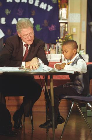 Bill reads with a student