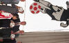 In this photograph from the 1994 FIFA World Cup opening ceremonies in Chicago, U.S. President Bill Clinton and German Chancellor Helmut Kohl stand together, each holding a soccer ball. They are joined by other officials and a young girl in a red and white striped jersey. Above them hangs a large banner featuring a stylized black-and-white illustration of a soccer player about to kick a red and white ball. The scene takes place against the backdrop of large, classical-style stone columns at Soldier Field.