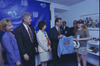 On the left, First Lady Hillary Clinton and President Bill Clinton look on with smiles as Alan Rothenberg, then-President of U.S. Soccer, presents a vintage 1994 World Cup denim jacket to a young woman. The young woman, wearing a "WorldCupUSA94" baseball cap and a gray t-shirt, beams as she receives the gift. Standing between Rothenberg and the President is a woman in a cream-colored blazer and a colorful, flag-patterned scarf.