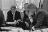 Scheduling Meeting Black and white photograph. President Clinton participates in a scheduling meeting with Director of the Office of Scheduling and Advance, Billy Webster. President Clinton is shown with his hand covering his mouth in thought.