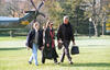 South Lawn President Clinton, Hillary Rodham Clinton, and Chelsea Clinton walk across the White House South Lawn together. President Clinton caries a bag in his left hand and a hat in his right hand. The Marine Helicopter, Marine 1, can be seen in the background.