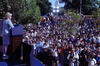 First Lady Hillary Rodham Clinton Stands on stage, behind a podium, looking down toward a crowd of people