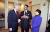 President Clinton stands and visits with Rev. Jesse Jackson, Sec. Alexis Herman. President Clinton holds a diet coke can in his left hand.