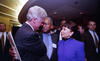 President Clinton stands and visits with Ernest Green and Sec. Alexis Herman