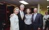 A photograph shows Hillary Clinton, Bill Clinton, Chelsea Clinton, and a man in a suit posing together inside what appears to be a stadium locker room.