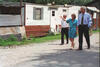 President Clinton Tours Tyner, Kentucky President Clinton walks on a street with two others. a white mobile home is in the bcackground.