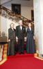 Millennium Celebration Dinner President Clinton, Hillary Rodham Clinton, and Chelsea Clinton stand together in the doorway of the East Room. The Grand Staircase decorated with Christmas Garland can be seen in the background.