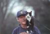 Socks the cat stands on top of President William Jefferson Clinton outside of the White House