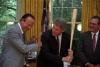 President Clinton poses with a baseball bat President Clinton poses with a baseball bat in the Oval Office after receiving it from St. Louis Cardinals Hall of Famer Stan Musial