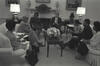 Black and white photograph. President Clinton sits in the Oval Office with Black Women's Leadership including: Maya Angelou, Dorothy Height, Delores Tucker, Alexis Herman, and Maggie Williams,