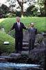 Garden of Iikura House President Clinton stands with his arms open. Prime Minister Kiichi Miyazawa also stands in the garden. Both men are smiling