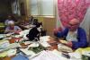 Socks the cat visiting the U.S. Soldiers and Airmen's Home. Senior citizens are pictured reading the mail as Socks sits on the table, September 16, 1993, Photographer: Barbara Kinney