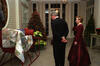 President Clinton and First Lady Hillary Rodham Clinton view Christmas decorations in the White House. In the photograph President Clinton and the First Lady look at a sleight with a quilt. They are dressed in formal attire