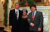 Christmas Day President Clinton, Roger Clinton, and Virginia Kelley pose for a photograph in front of a fire place in the old family Dining Room
