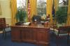 Socks the cat sits at the Resolute Desk in the Oval Office