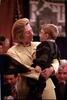 Healthright event Hillary Rodham Clinton stands holding Ryan Moore.