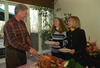 Carving Turkey President Clinton carves a roasted turkey while Hillary Rodham Clinton and Chelsea Clinton wait to be served. The First Lady and Chelsea Clinton hold white plates in their hands. The Clinton's all stand next to a table. The Clinton's are smiling and laughing.