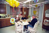 Chelsea's Birthday President Clinton, Hillary Rodham Clinton, and Chelsea Clinton celebrate Chelsea's 15th birthday in the White House private residence kitchen. All sit around a a kitchen table. Balloons and streamers are hung in the kitchen. Chelsea wears a celebration birthday top hat.