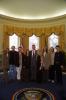 President Clinton poses for a photo with musician Sheryl Crow and her band in the Oval Office