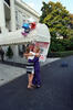 South Portico Welcome Home President Clinton and Hillary Rodham Clinton hug Chelsea Clinton, at the South Portico. The family stands in front of a covered awning decorated with balloons and a sign that reads, "Welcome Home Chelsea."