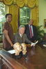 Anniversary of the Voting Rights Act of 1965 President Clinton sits at the resolute desk in the Oval Office. Representative Cynthia McKinney and Representative John Lewis stand and pose for a photo with the President.