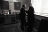 Black and white photograph. President Clinton stands very close to Senator George Mitchell