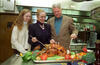 Kitchen at Camp David President Clinton, Hillary Rodham Clinton, and Chelsea Clinton pose for a photograph with a roasted turkey in the kitchen at Camp David