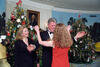 President Clinton and First Lady Hillary Rodham Clinton greet Chelsea Clinton. President Clinton faces Chelsea Clinton with his arms out. Chelsea Clinton faces Bill Clinton with her arms out, prepared to give the President a hug.