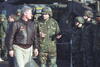 President Clinton inspects the troops in a tank convoy staging area with General William Crouch in Taszar, Hungry, January 13, 1996. President Clinton wears leather bomber Jacket and speaks to the general who is wearing military fatigues and helmet. 