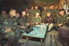 President Clinton meets with troops while huddled in a bunker at Outpost Lima, Bosnia