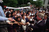 President Clinton's Birthday President Clinton is greeted by his staff for his birthday. President Clinton is seen in a crowd of his own staff shaking hands. A banner in the background reads, "Happy Birthday Mr. President."