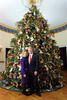 President Clinton and Hillary Rodham Clinton posing next to the 1996 White House Christmas tree