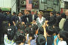 Okuma shopping district in Japan President William J. Clinton and First Lady Hillary Rodham Clinton visiting with school children in the Okuma shopping district in Tokyo, Japan. The children greet the Clintons and give the First Lady a bouquet of flowers