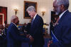 President Clinton stands with a survivor of Tuskegee Syphilis Study on African-American men
