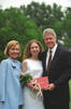 President Clinton, Hillary Rodham Clinton, and Chelsea Clinton pose for a photograph at Chelsea Clinton's high school graduation. President Clinton and Chelsea both hold Chelsea's diploma. Chelsea also holds a bouquet of flowers.