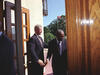 President Clinton holds the door open to Central High and greets Ernest Green as he enters the school