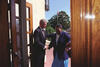 President Clinton holds the door open to Central High and greets Minniejean Brown Trickey as she enters the school