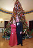 President Clinton and Hillary Rodham Clinton posing next to the 1997 White House Christmas tree.