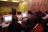 State of the Union Prep 1998 President Clinton rehearses his State of the Union Speech at a podium in the Family Theater in the White House. Speech writing staff are shown working behind a row of computers