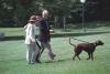 The President, First Lady, and Chelsea walk to the White House with Buddy the brown Labrador dog. President Clinton is turned toward Chelsea and Hillary Rodham Clinton. Buddy is on a leash