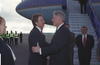 President Clinton greets British Prime Minister Tony Blair. President Clinton places his left hand on Blairs elbow. The two stand outside of Airforce One.