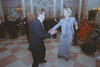 First Lady Hillary Rodham Clinton and President Václav Havel dance in a room in the White House. Members of the United States Marine band play intruments in the back ground. Other State Dinner attendees dance in the background.