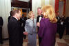 President Clinton and First Lady Hillary Rodham Clinton stand in a circle with President Václav Havel and his wife Dagmar Havlová. Photographers take photos in the background. 