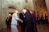 First Lady Hillary Rodham Clinton stands and shakes hands with President Václav Havel. President Clinton stands and speaks with Dagmar Havlová. They stand outside of the White Houise. Three uniformed soldiers can be seen in the background standing at attention, holding rifles in front of them.