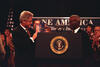 President Clinton holds up a report titled 'One America 21st Century' with historian, John Hope Franklin, at an event where the President addresses the President's Advisory Board on Race