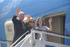Koln-Bonn International Airport President Clinton, Hillary Rodham Clinton, and Chelsea Clinton wave on boarding stairs outside of Air Force One.