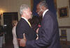 President Clinton stands close to civil rights attorney, Vernon Jordon. Jordan holds Clinton's right arm.