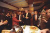 Hot Dogs President Clinton, Secretary Madeleine Albright, Ehud Barak and Yassar Arafat gather around a table of hot dogs. The room is filled with diplomats and representatives.