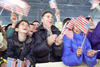 Children wave American Flags at the Ferizaj Sports Pavilion in Ferizaj, Kosovo