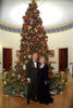 President Clinton and Hillary Rodham Clinton posing next to the 1999 White House Christmas tree for their official Christmas portrait